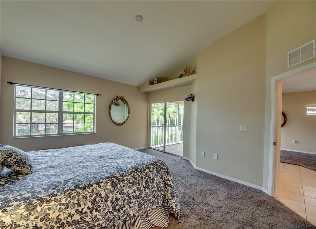 5180 Park Road, Unit 4 Fort Myers, FL 33908 - Photo 14 of 24 a large bed sitting in a bedroom next to a window and a mirror