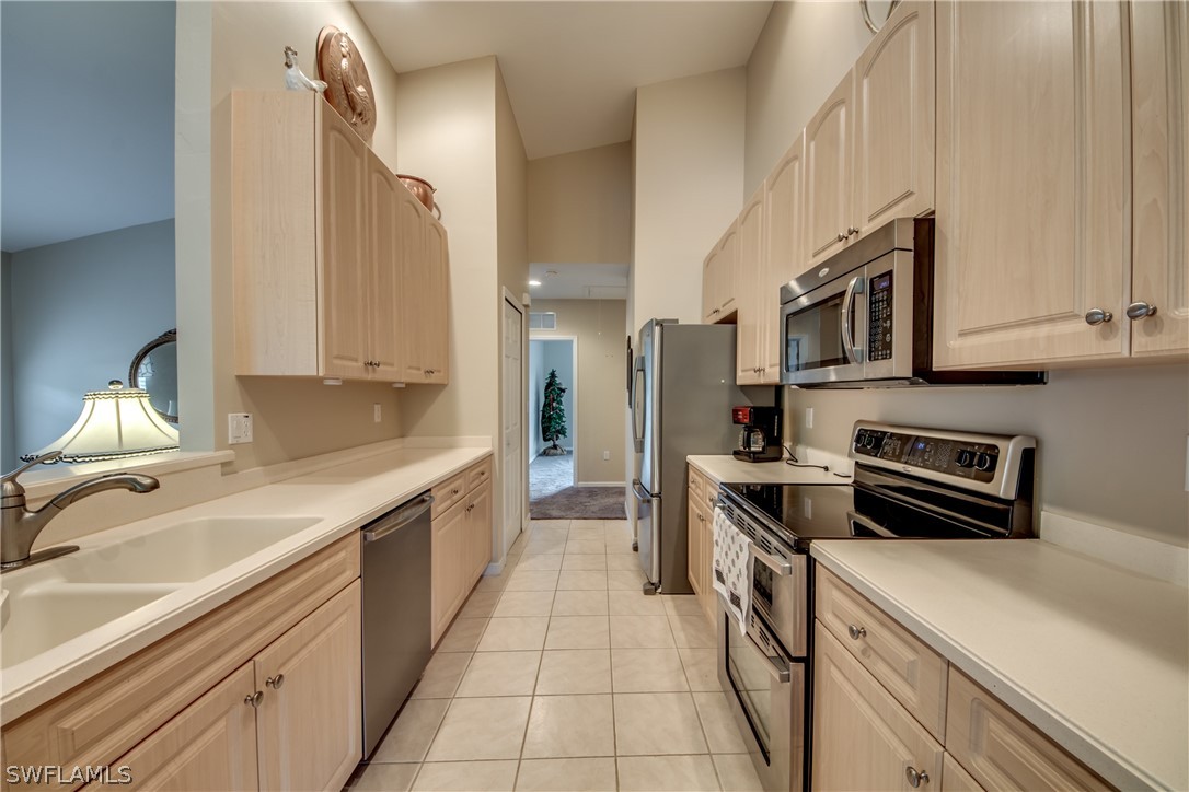 5180 Park Road, Unit 4 Fort Myers, FL 33908 - Photo 5 of 24 a kitchen with stainless steel appliances a sink stove and cabinets