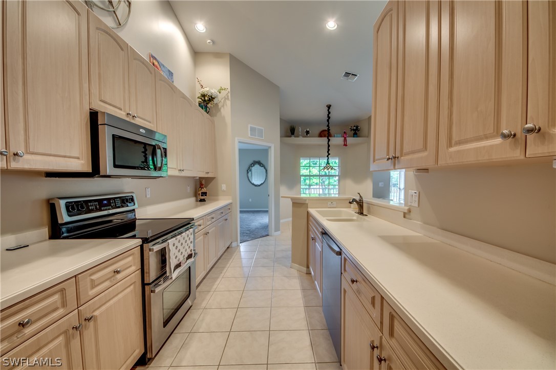 5180 Park Road, Unit 4 Fort Myers, FL 33908 - Photo 7 of 24 a kitchen with stainless steel appliances a sink stove and cabinets
