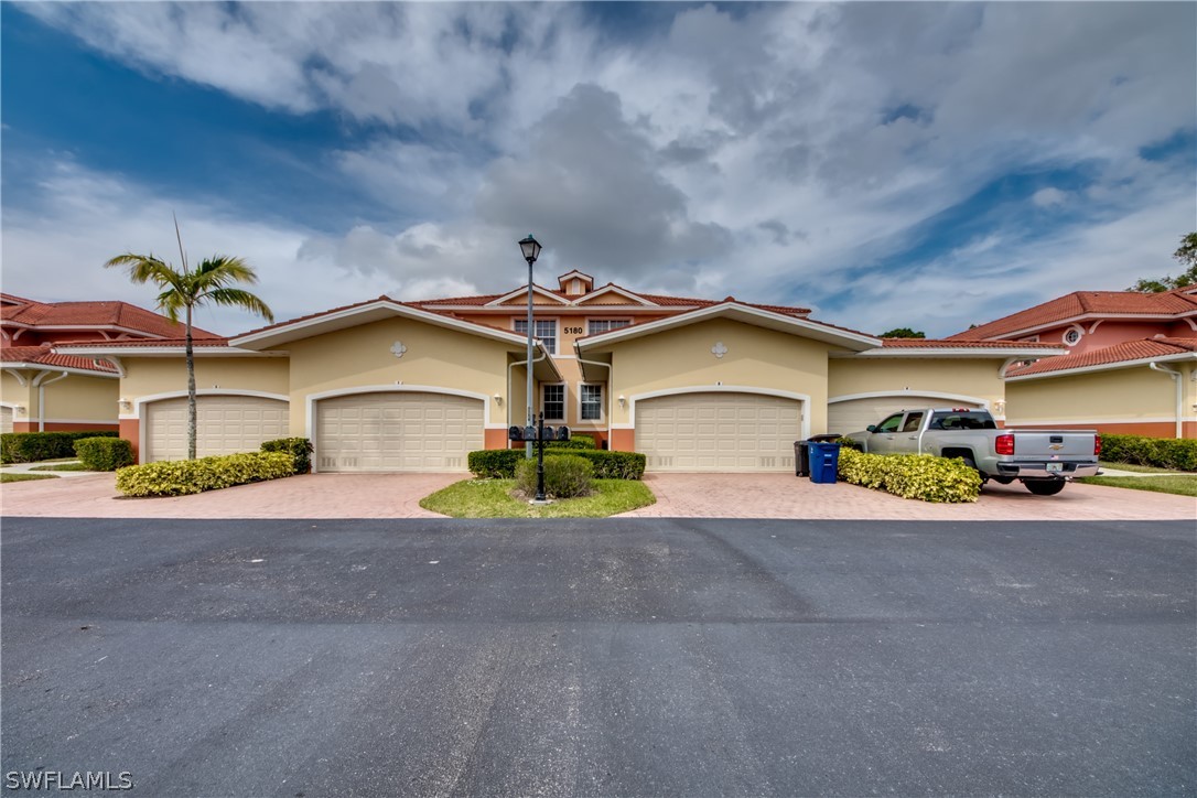 5180 Park Road, Unit 4 Fort Myers, FL 33908 - Photo 8 of 24 a front view of a house with a yard and garage