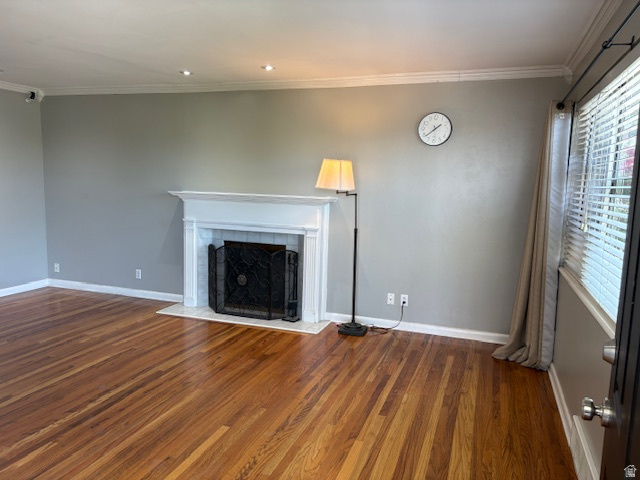 2313 150 East Bountiful, UT 84010 - Photo 5 of 39 Living space featuring wood-finish flooring, a white mantel fireplace with a dark metal screen, crown molding, recessed lighting, and a window with blinds