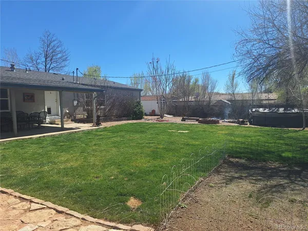 a front view of a house with a yard and trees