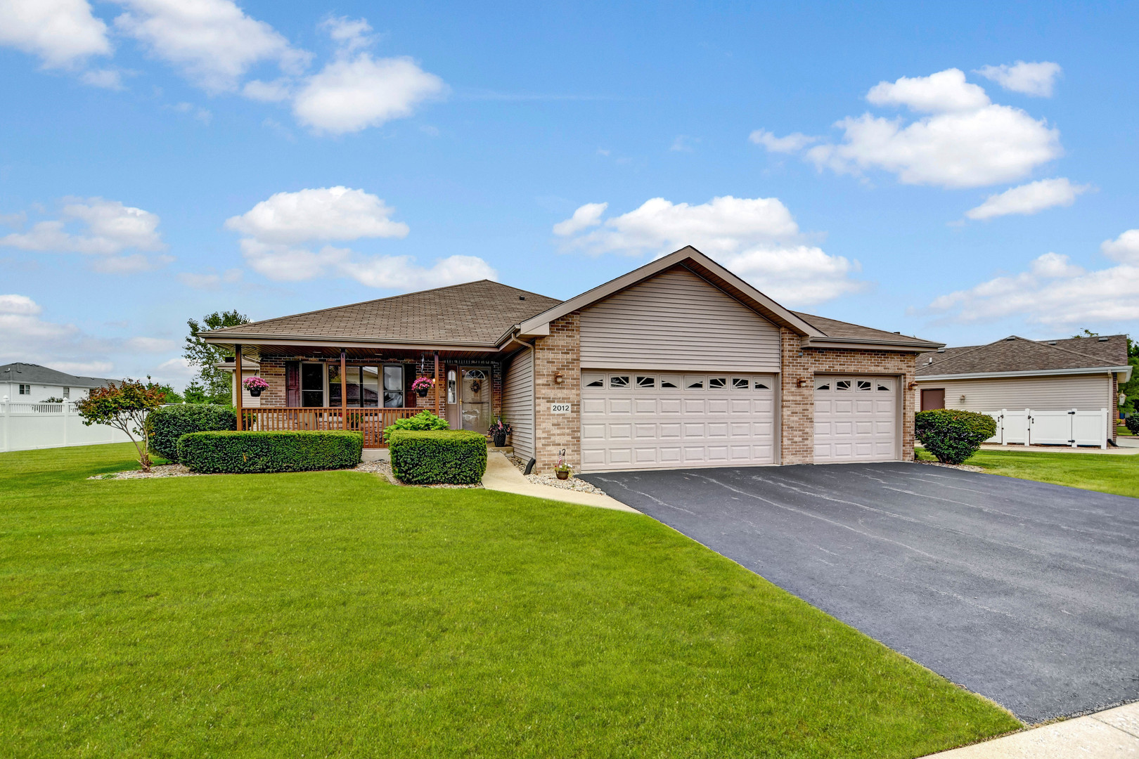 a view of a house with a yard and fence