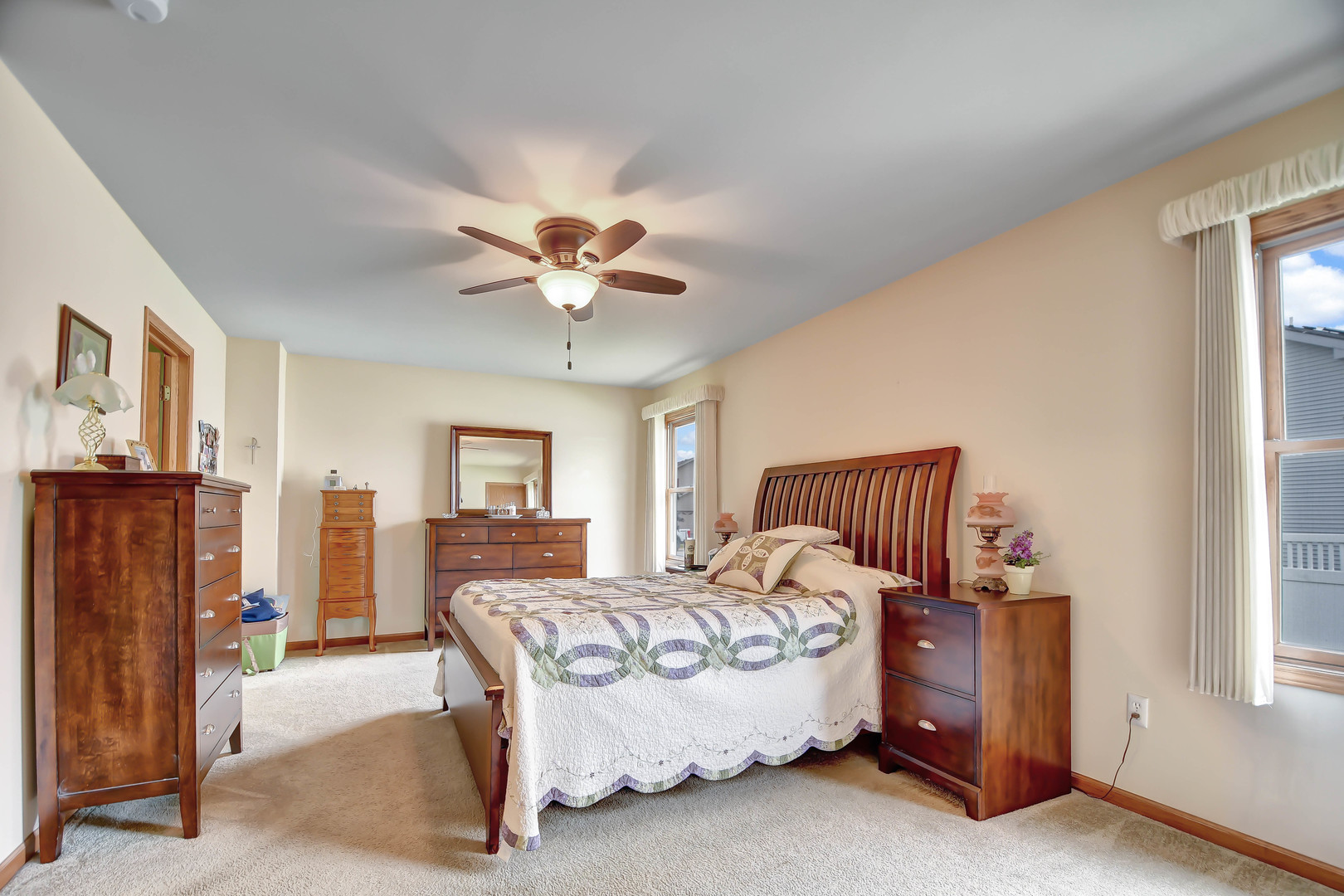 2012 Willow Brook Drive Bourbonnais, IL 60914 - Photo 19 of 33 a spacious bedroom with a bed and a chandelier