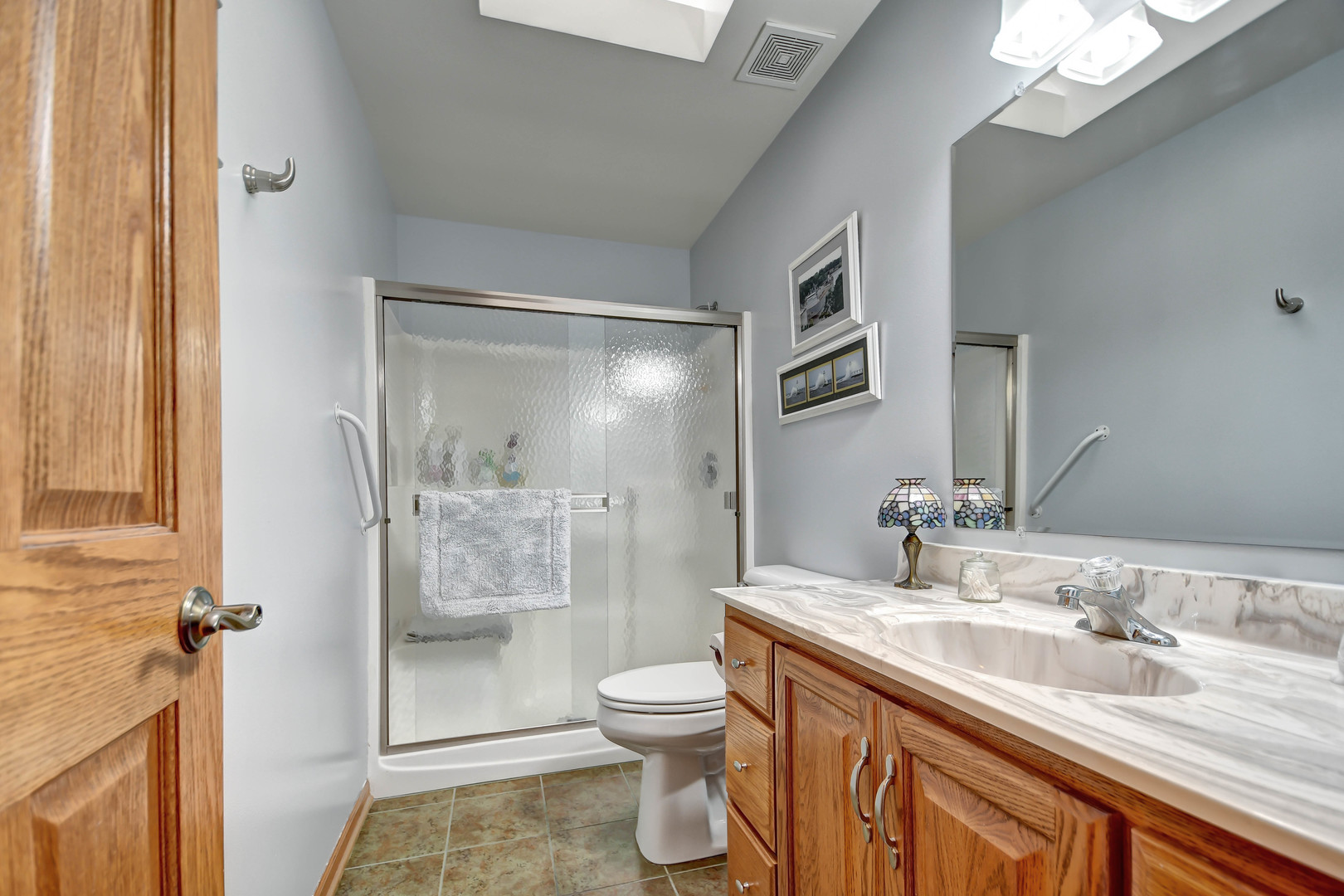 2012 Willow Brook Drive Bourbonnais, IL 60914 - Photo 24 of 33 a bathroom with a granite countertop sink toilet a mirror and shower