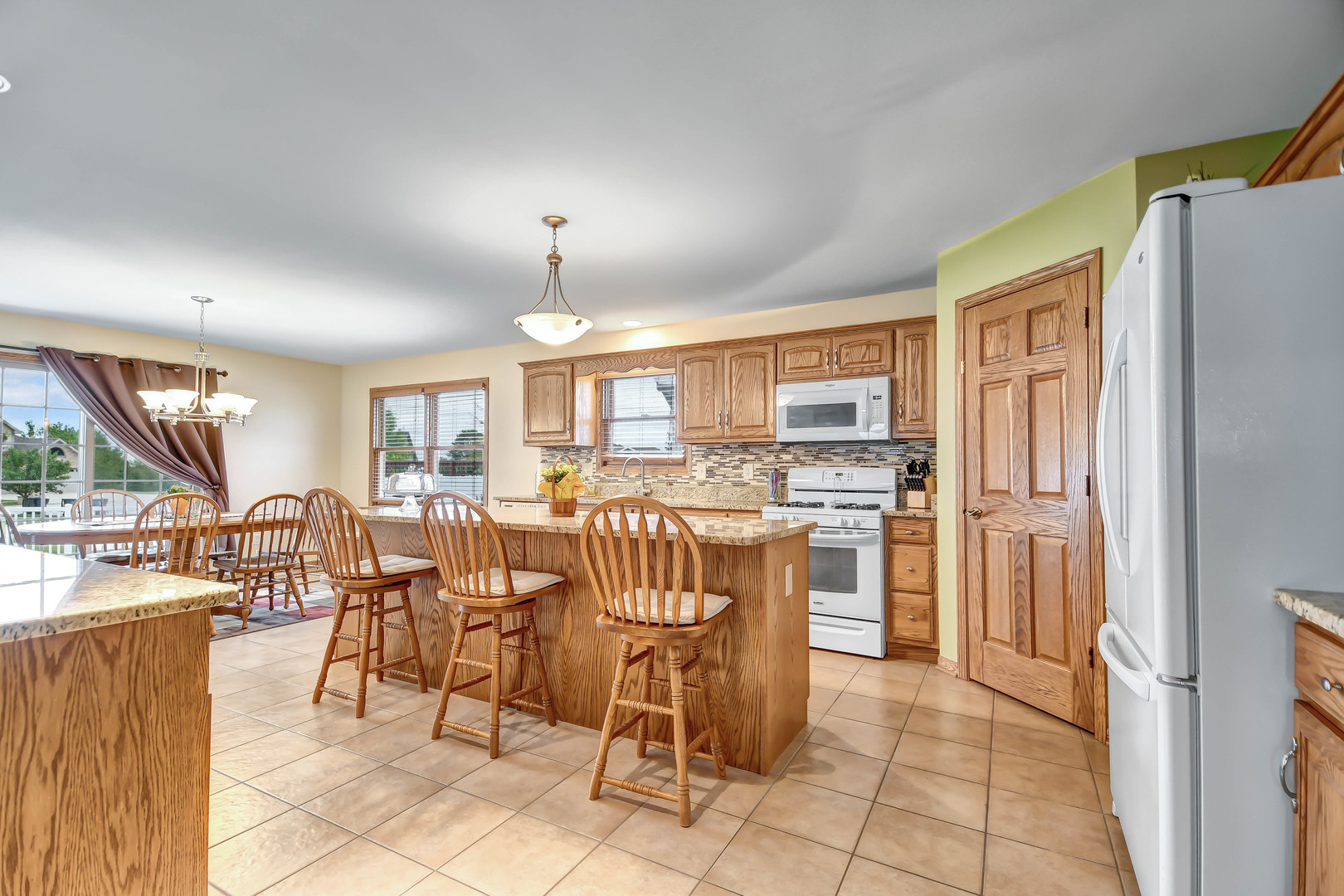 2012 Willow Brook Drive Bourbonnais, IL 60914 - Photo 10 of 33 a dining hall with stainless steel appliances a dining table and chairs