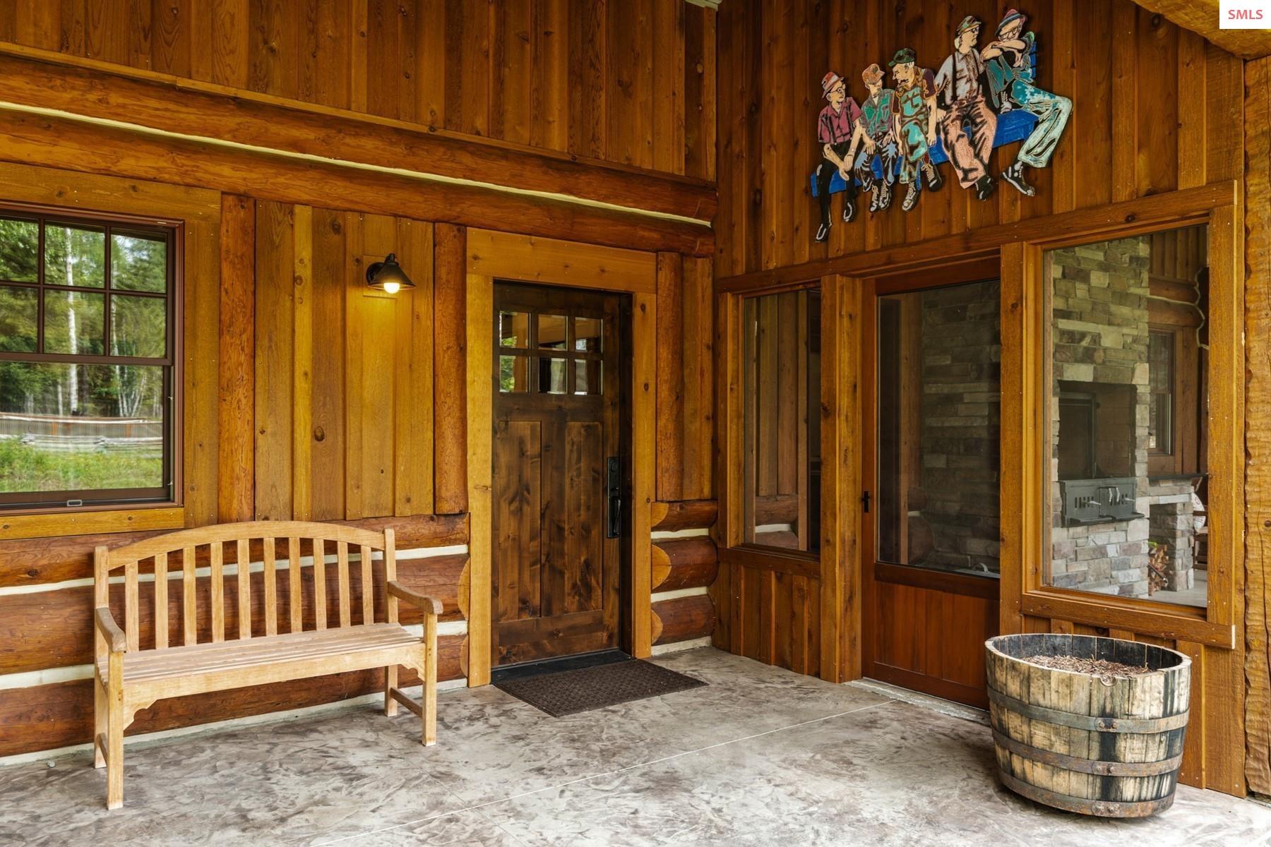 7017-7019 Colburn Culver Road Sandpoint, ID 83864 - Photo 4 of 54 Covered entry invites guests into the home or to enjoy the afternoon in the screened outdoor space