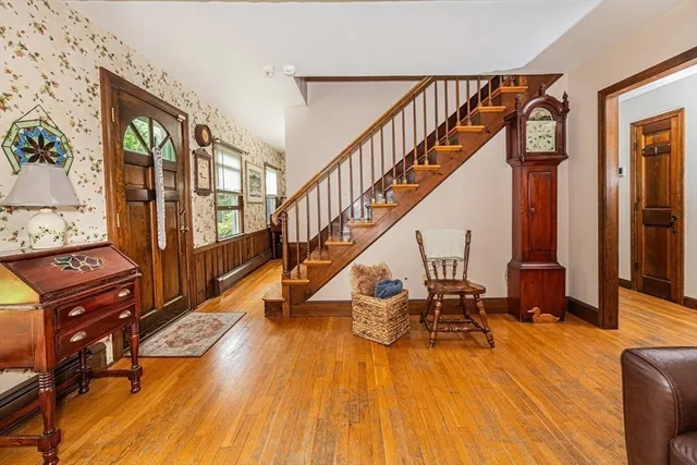 a view of hall way with furniture and wooden floor