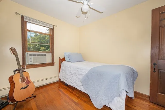 a bedroom with a bed and window