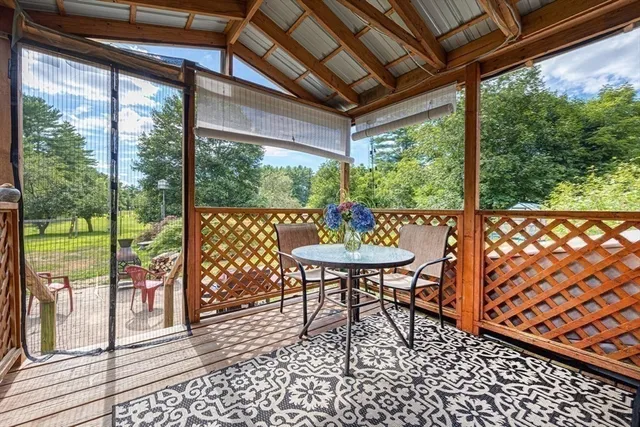 a view of porch with a table and chairs