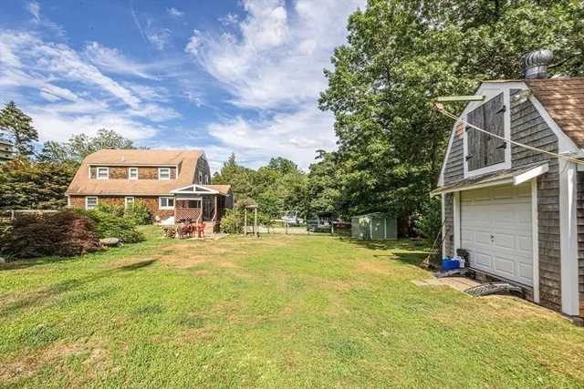a view of a house with a yard and sitting area