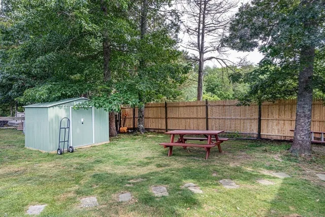 a backyard of a house with table and chairs