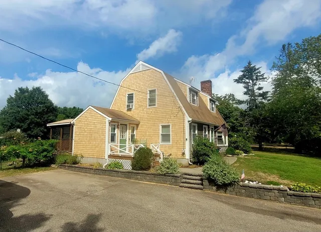 a front view of a house with a garden