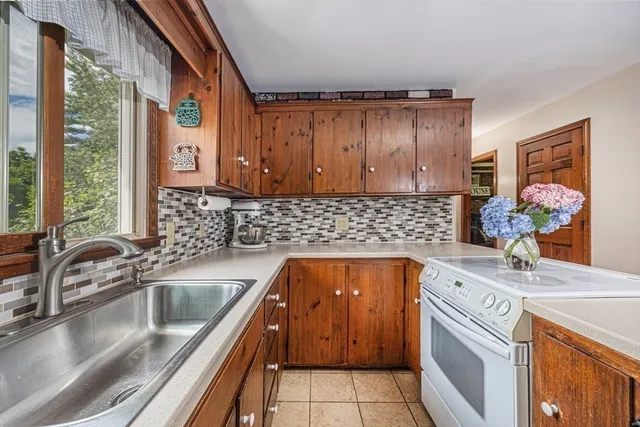 a kitchen with a sink stove and cabinets