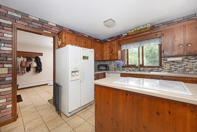 a kitchen with refrigerator and window