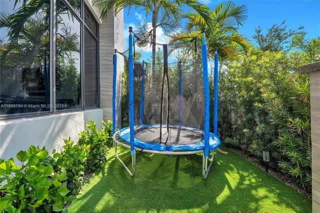 a view of a backyard with plants and a patio