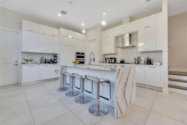 a kitchen with stainless steel appliances kitchen island granite countertop a sink and cabinets