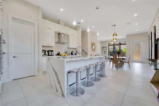 a kitchen with stainless steel appliances granite countertop a refrigerator and a stove top oven