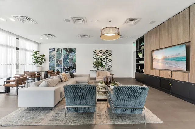 a kitchen with stainless steel appliances granite countertop table chairs sink and cabinets