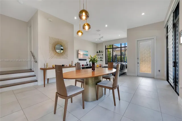 a view of a dining room and livingroom with furniture wooden floor and a rug