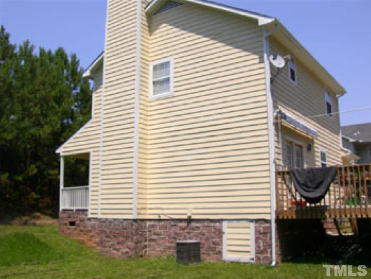 6311 Battleford Drive Raleigh, NC 27612 - Photo 2 of 6 a view of a house with a small yard and a large window