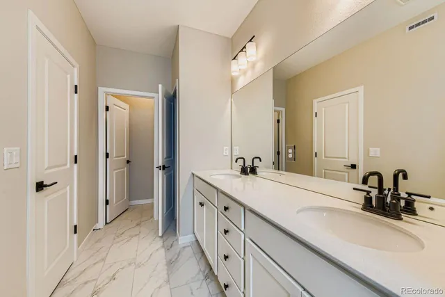 a spacious bathroom with a double vanity sink mirror and