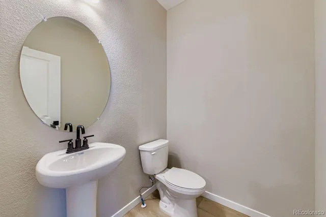 a bathroom with a sink a toilet and mirror