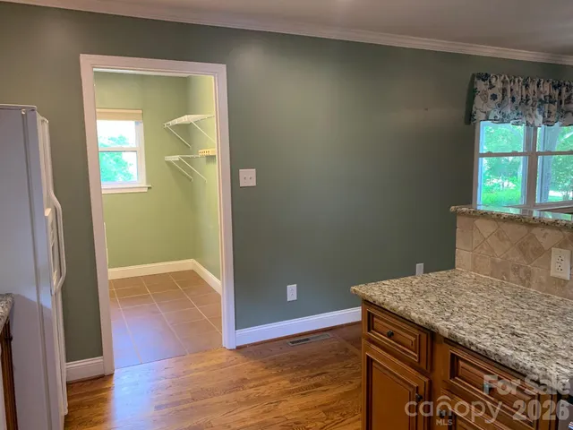 an empty room with wooden floor and a window