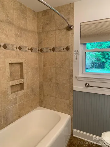 a bathroom with a bathtub and shower