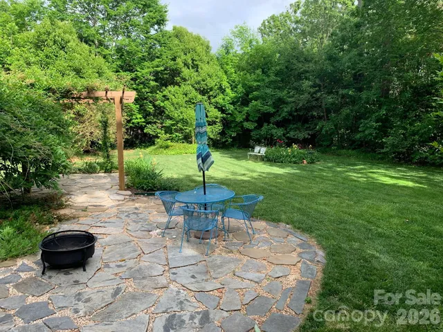 a view of a backyard with sitting area