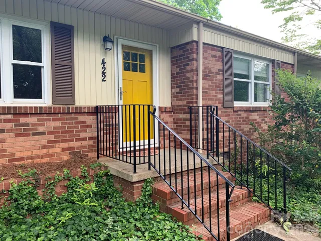 a view of front door and porch with wooden floor