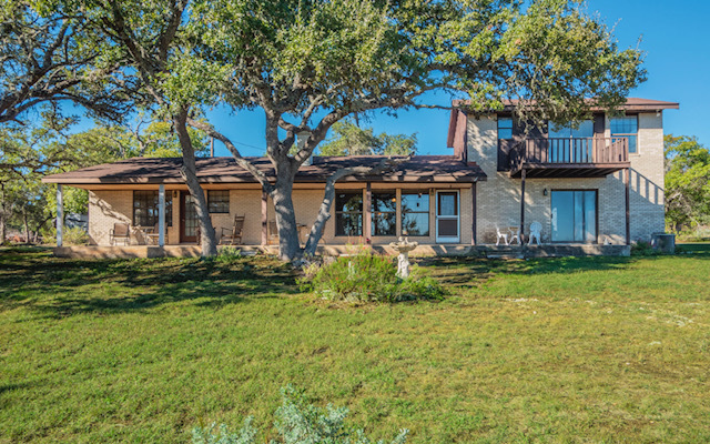 a front view of a house with swimming pool having outdoor seating