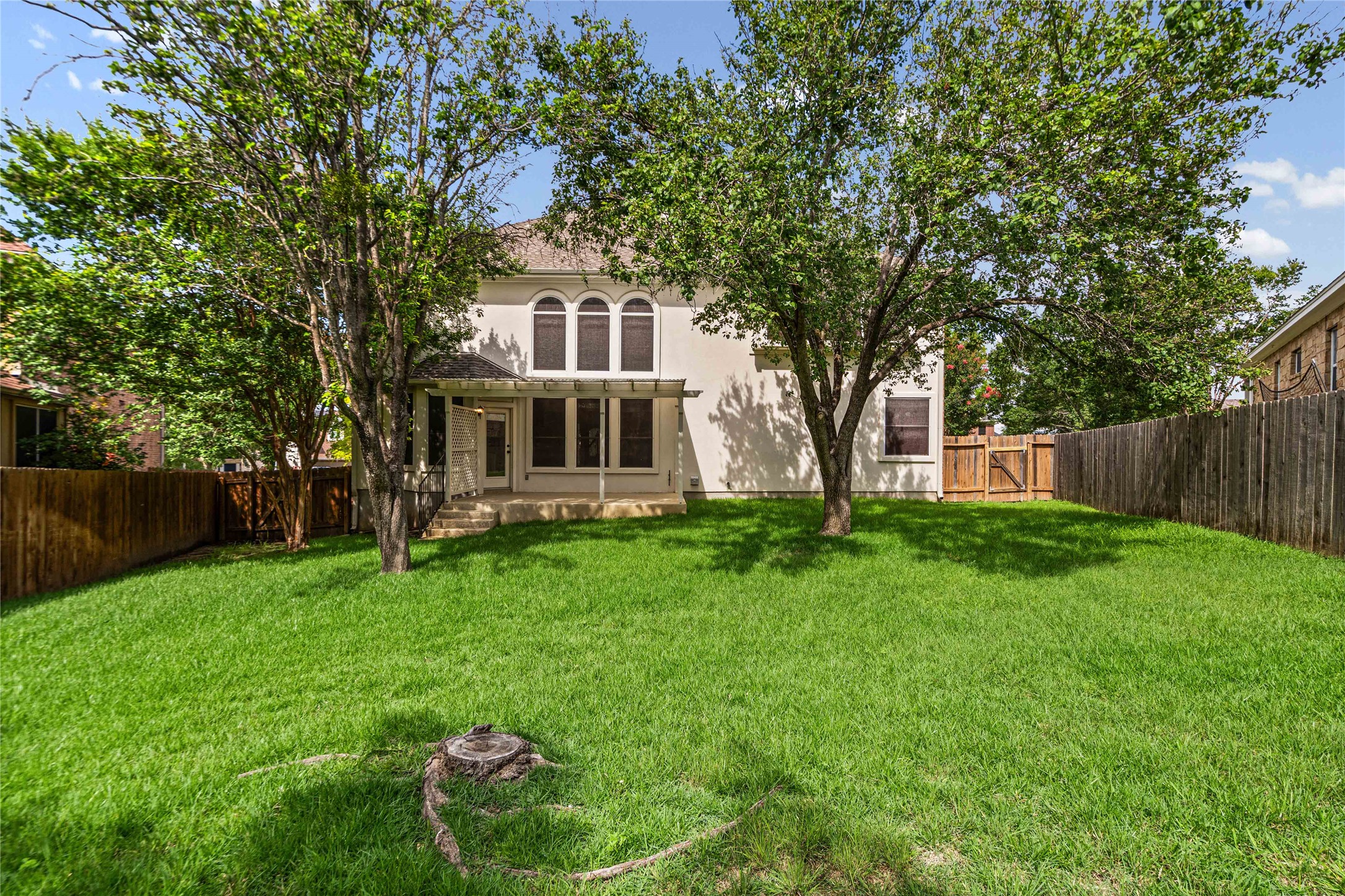 10700 Pointe View Drive Austin, TX 78738 - Photo 17 of 35 A generous backyard offers a private retreat with ample green space and a secluded patio.