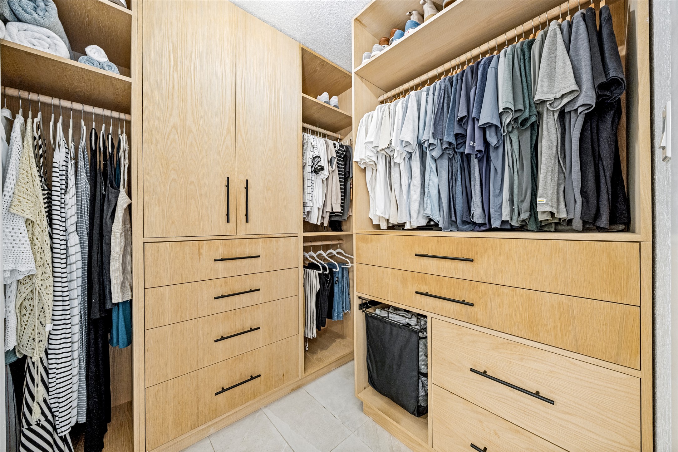 9205 Rowlands Sayle Road Austin, TX 78744 - Photo 19 of 25 Custom cabinetry and built-in drawers organize this well-appointed walk-in closet.