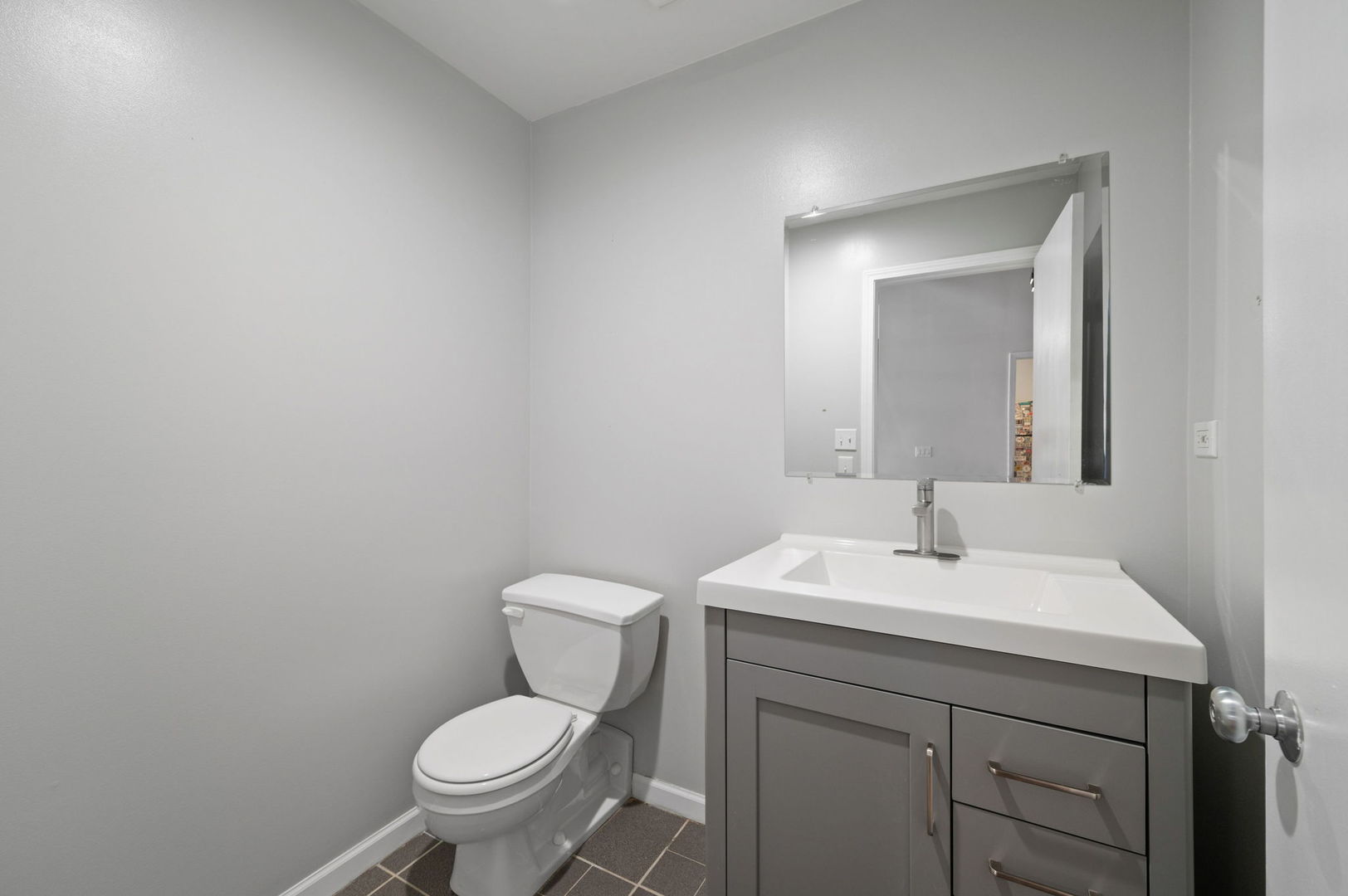 17 North Loomis Street, Unit 4D Chicago, IL 60607 - Photo 17 of 26 a bathroom with a toilet sink and mirror