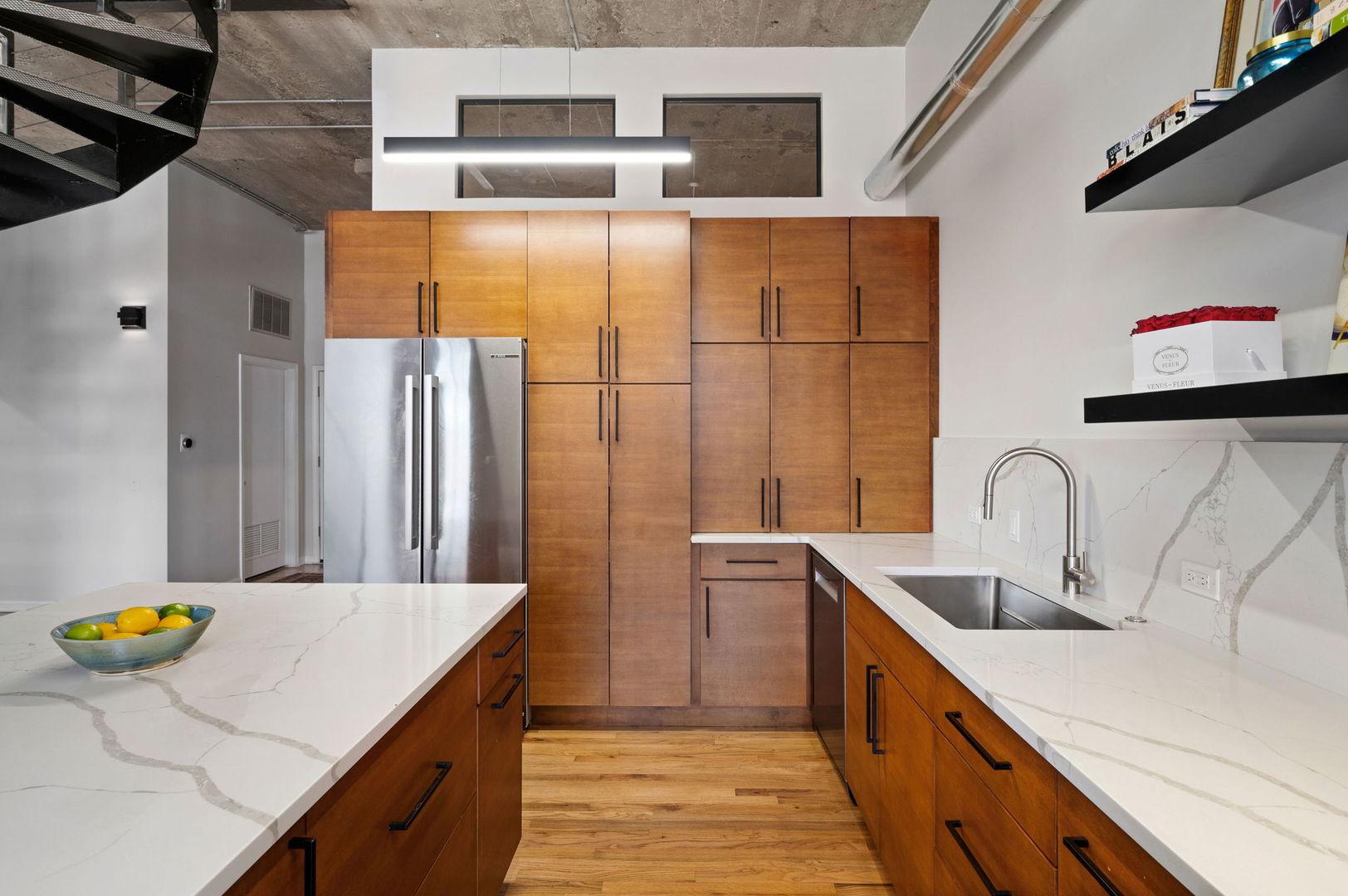 17 North Loomis Street, Unit 4D Chicago, IL 60607 - Photo 6 of 26 a kitchen with stainless steel appliances a sink and a refrigerator