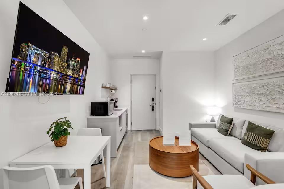 229 Southwest 9th Street, Unit 202 Miami, FL 33130 - Photo 2 of 35 a living room with furniture and a flat screen tv