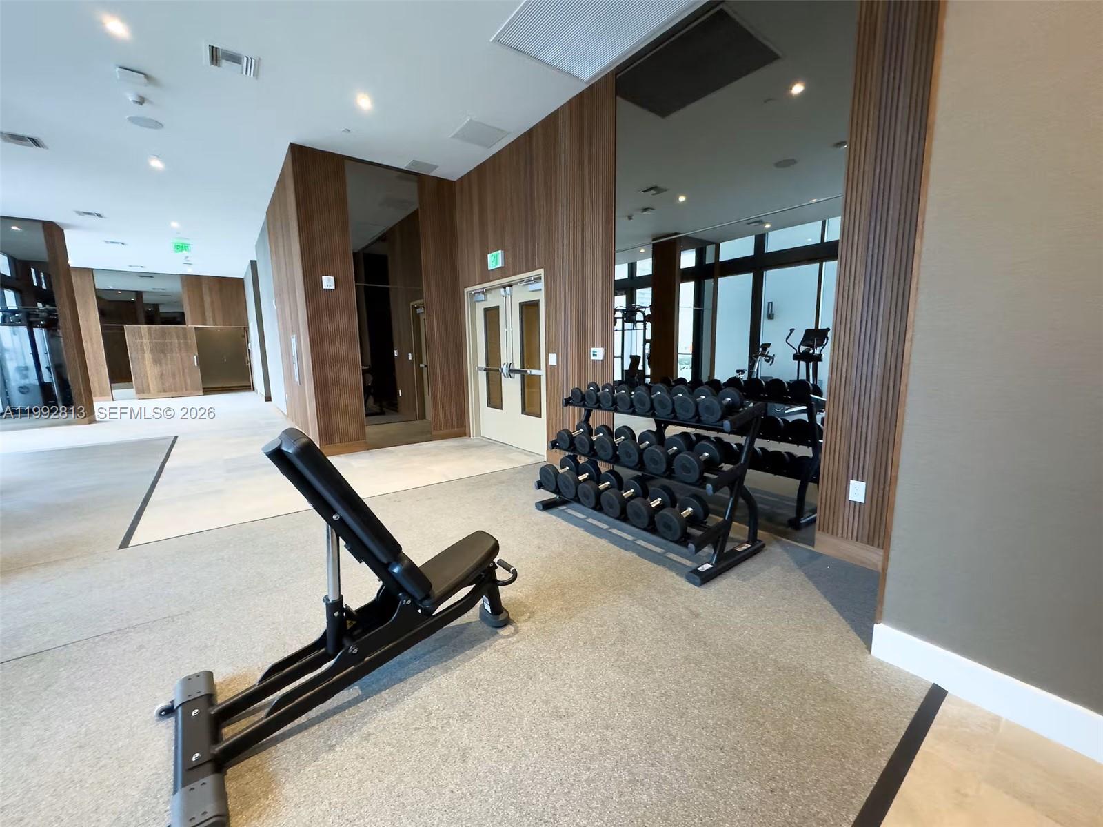 229 Southwest 9th Street, Unit 202 Miami, FL 33130 - Photo 24 of 35 a room with gym equipment and a large window