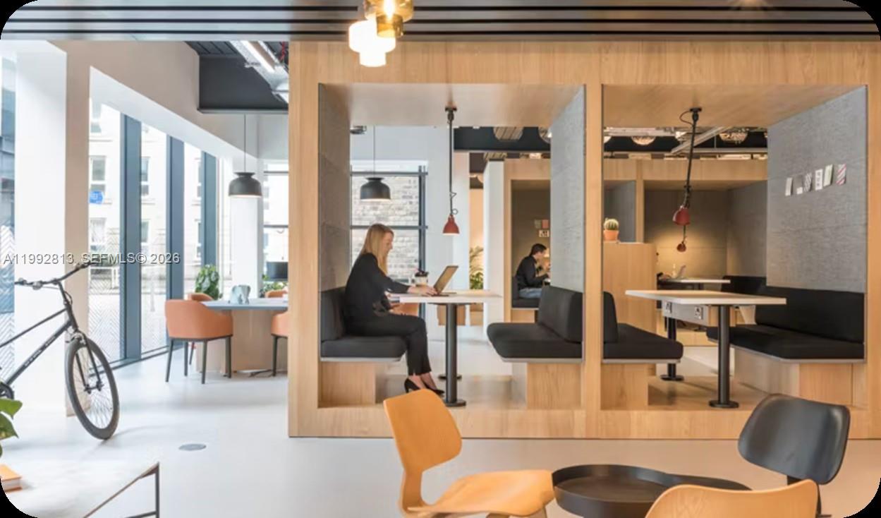 229 Southwest 9th Street, Unit 202 Miami, FL 33130 - Photo 27 of 35 a living room with furniture and a floor to ceiling window