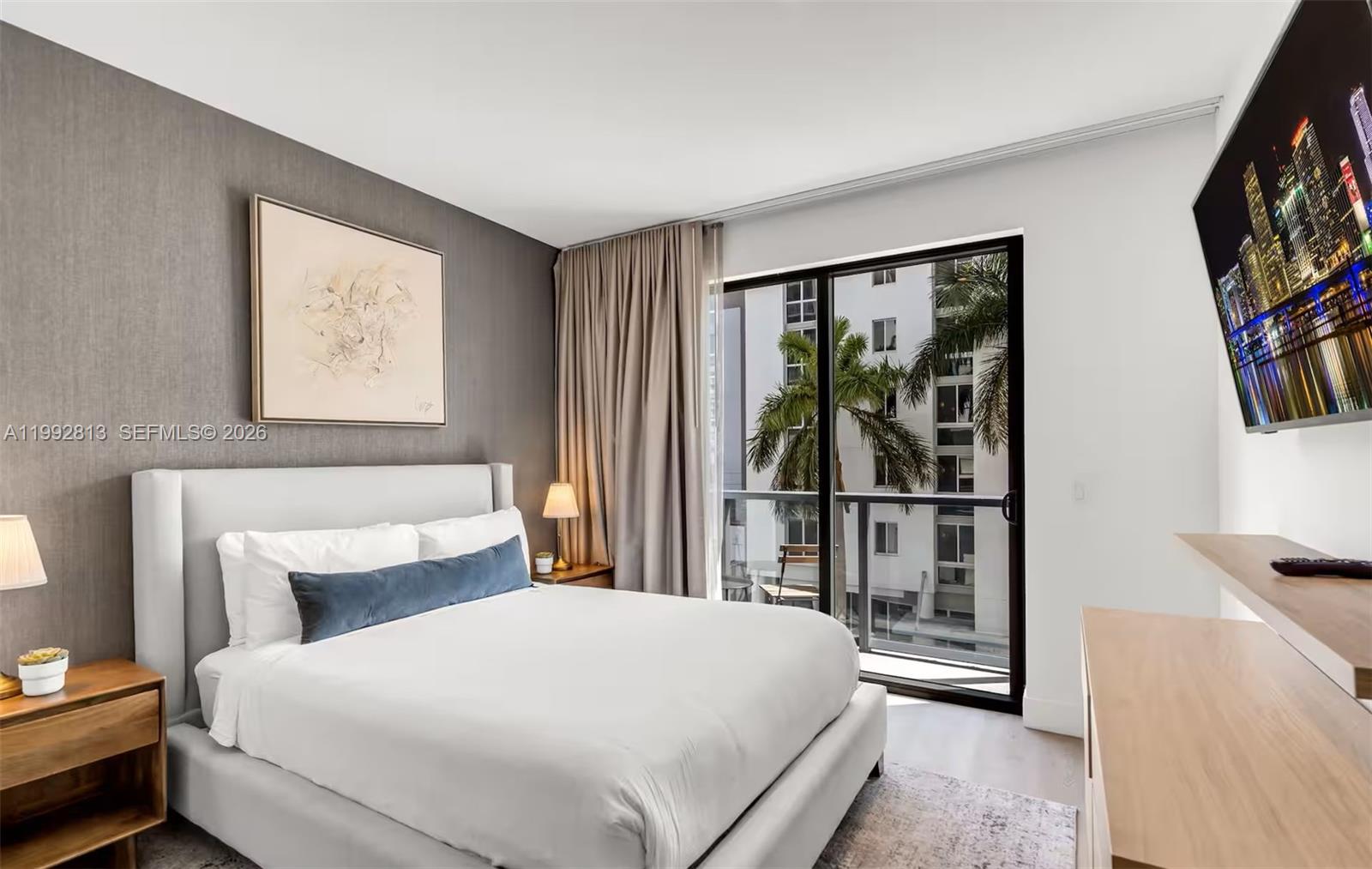 229 Southwest 9th Street, Unit 202 Miami, FL 33130 - Photo 3 of 35 a bedroom with a large bed and a window