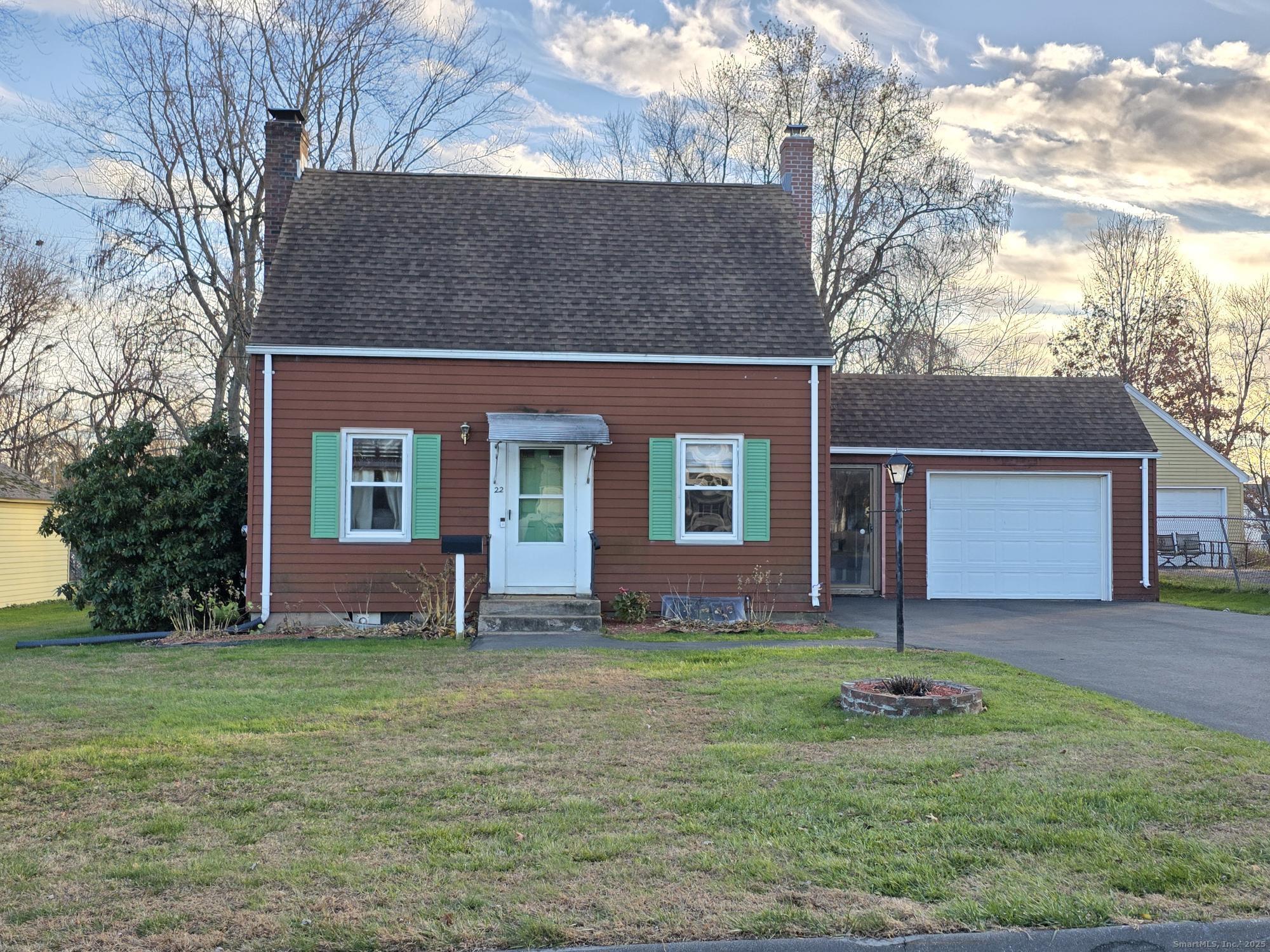 a front view of house with yard and green space