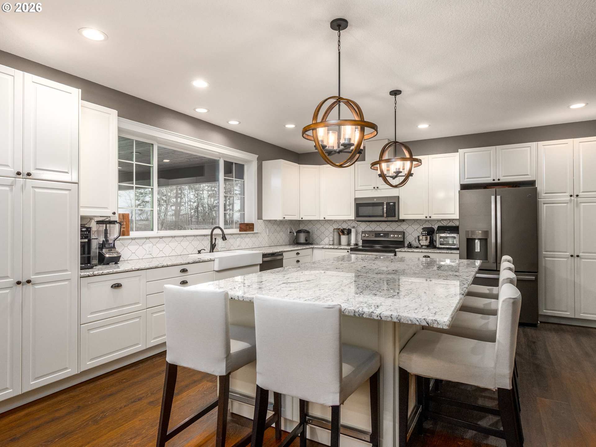 12950 South Barnards Road Molalla, OR 97038 - Photo 11 of 48 a kitchen with stainless steel appliances a dining table a stove a refrigerator cabinets and chairs
