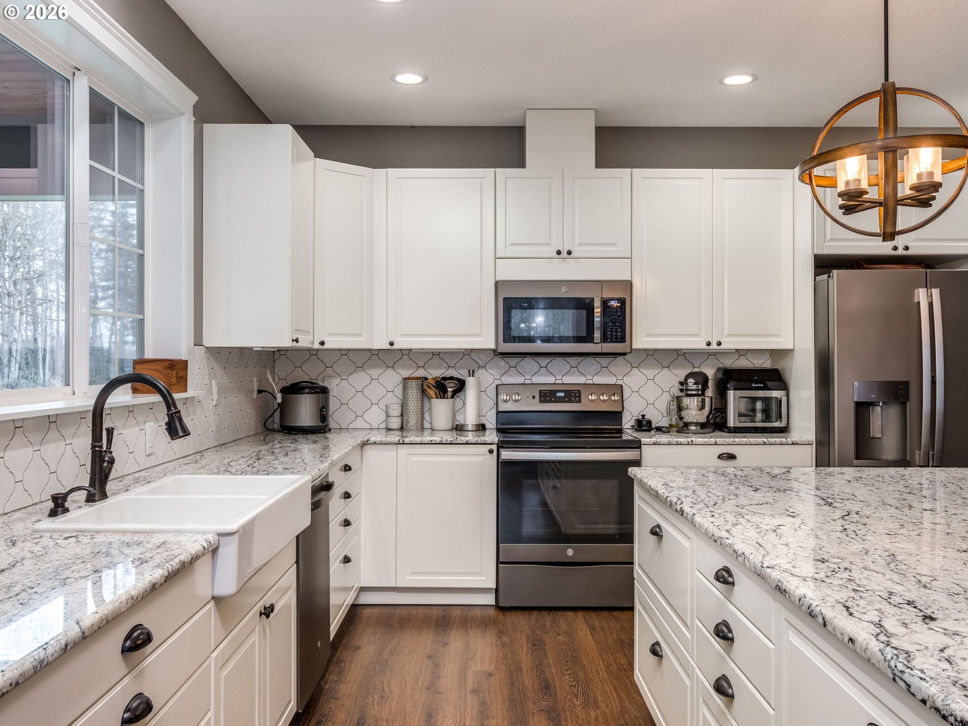 12950 South Barnards Road Molalla, OR 97038 - Photo 12 of 48 a kitchen with stainless steel appliances granite countertop a sink stove microwave and refrigerator