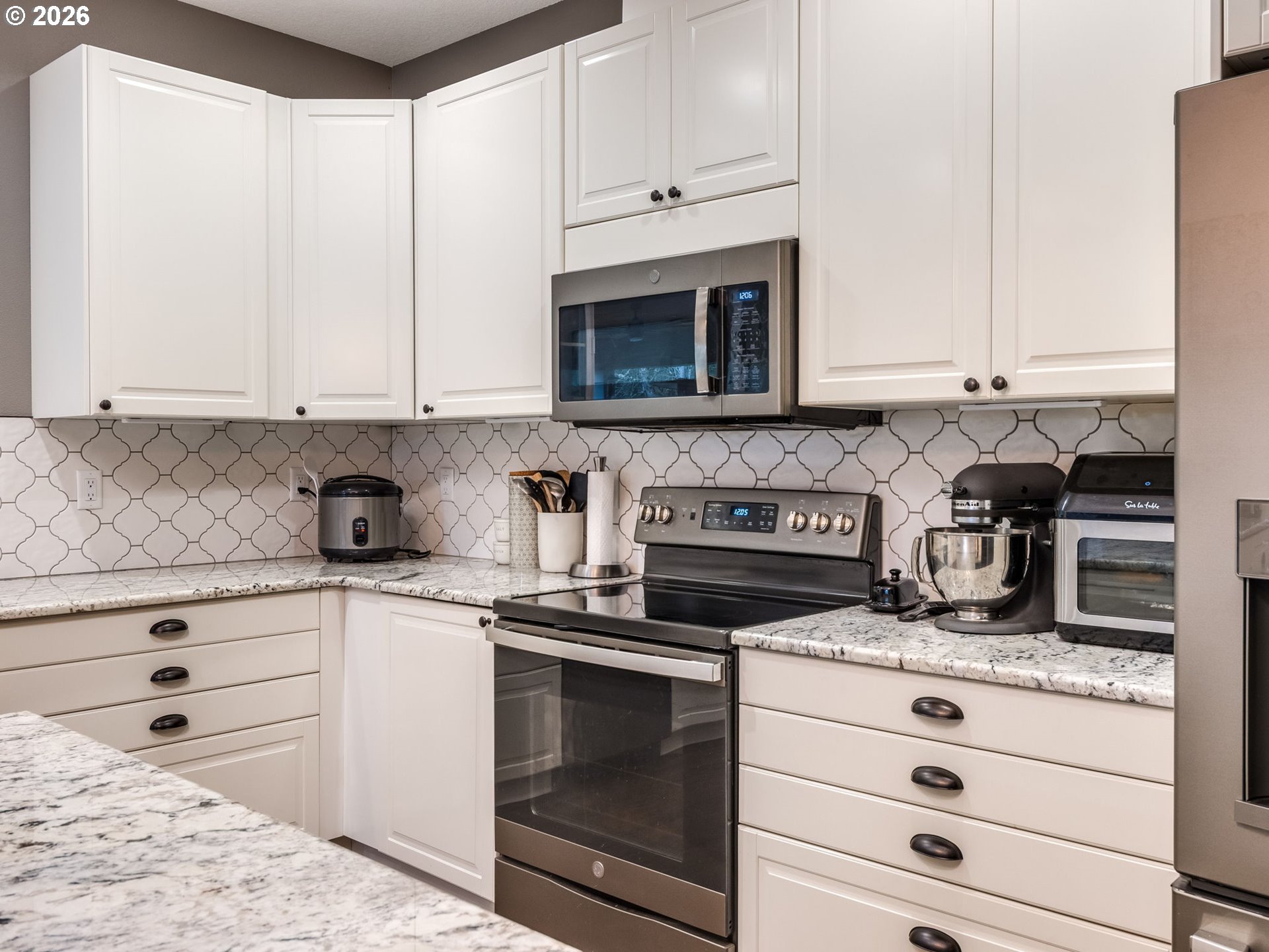 12950 South Barnards Road Molalla, OR 97038 - Photo 14 of 48 a kitchen with granite countertop white cabinets and white appliances