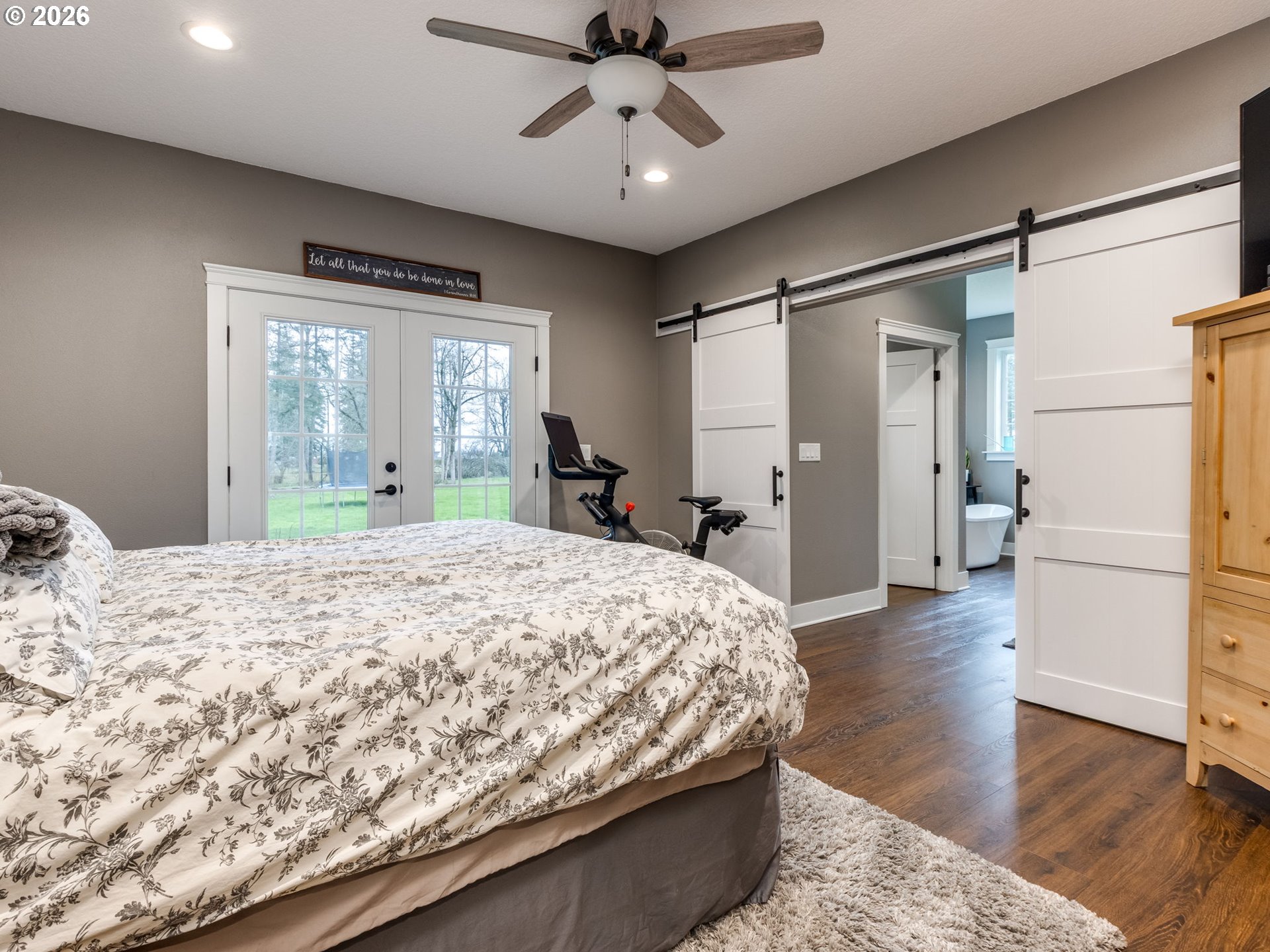 12950 South Barnards Road Molalla, OR 97038 - Photo 22 of 48 a spacious bedroom with a bed and a chandelier