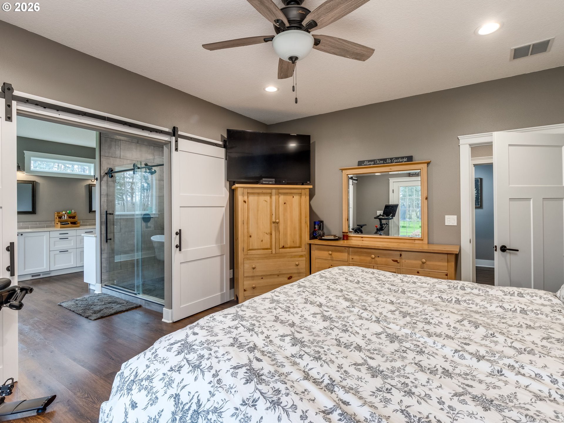 12950 South Barnards Road Molalla, OR 97038 - Photo 24 of 48 a bedroom with a bed and a large mirror with a flat tv screen