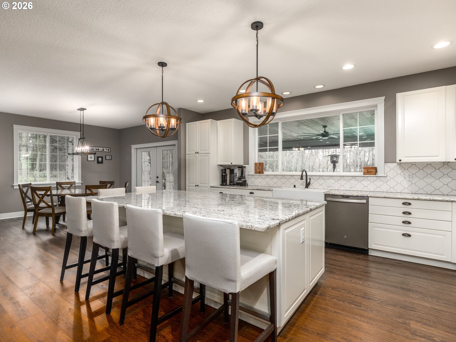 12950 South Barnards Road Molalla, OR 97038 - Photo 10 of 48 a kitchen with a dining table chairs and white cabinets