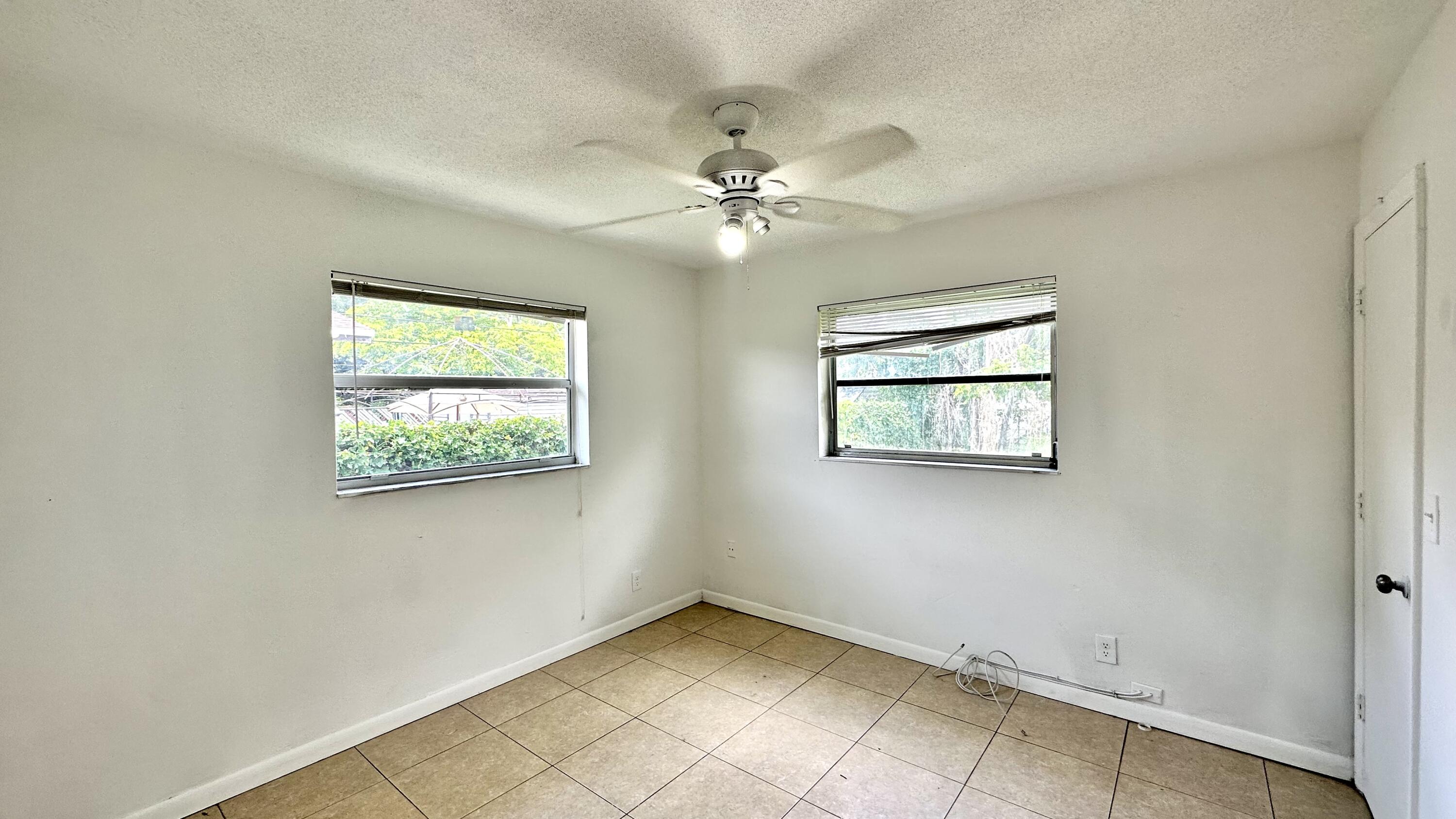 5745 Buchanan Street Hollywood, FL 33021 - Photo 12 of 20 an empty room with windows and fan