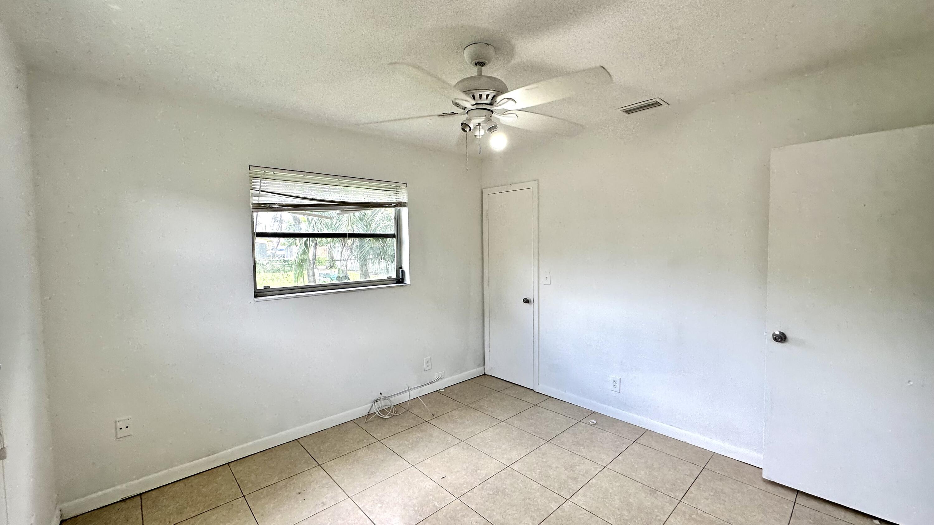 5745 Buchanan Street Hollywood, FL 33021 - Photo 13 of 20 an empty room with windows and fan