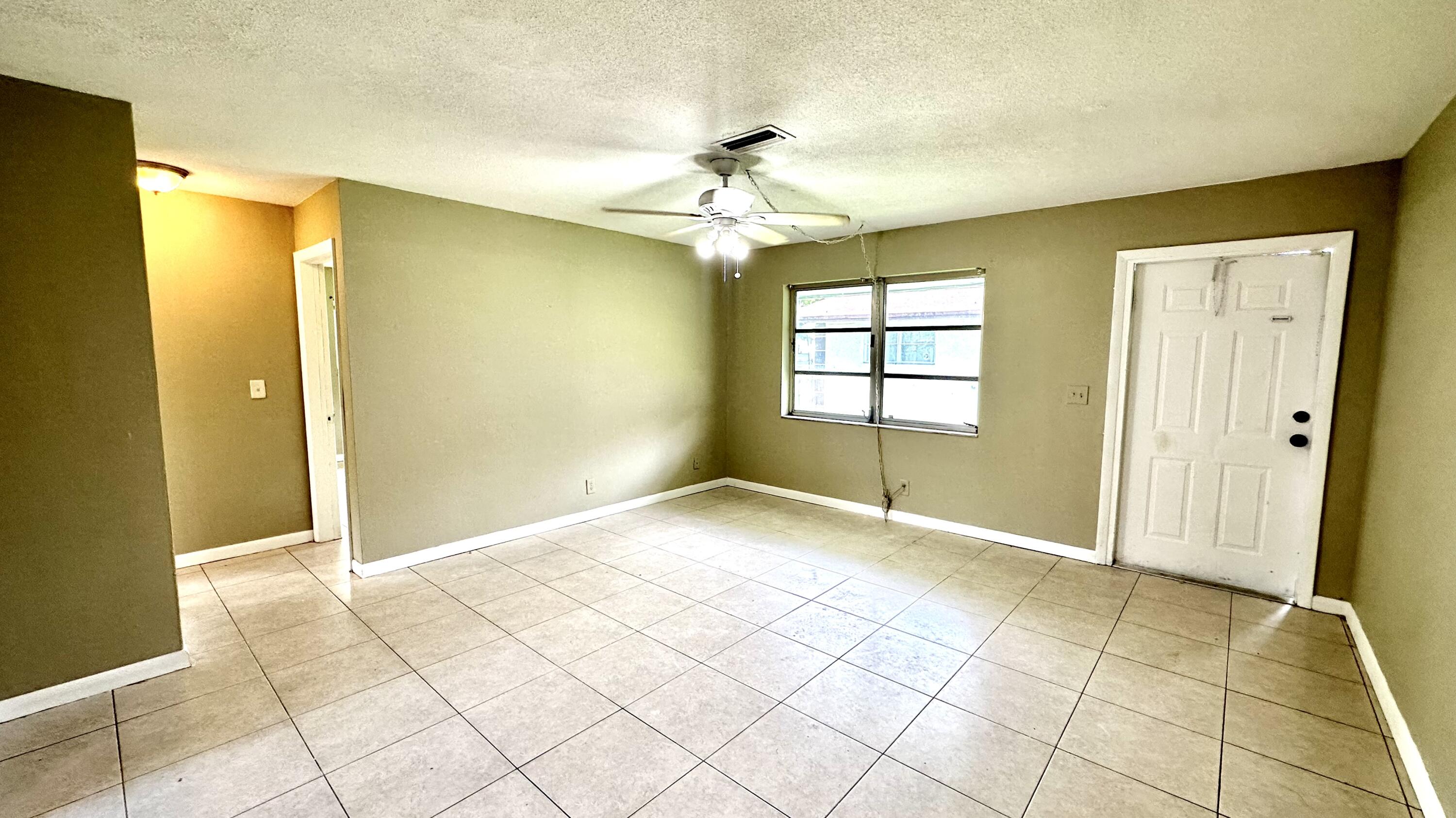5745 Buchanan Street Hollywood, FL 33021 - Photo 15 of 20 a view of an empty room with window and chandelier fan